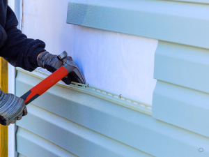 Professional Maple Grove siding contractor working on a house