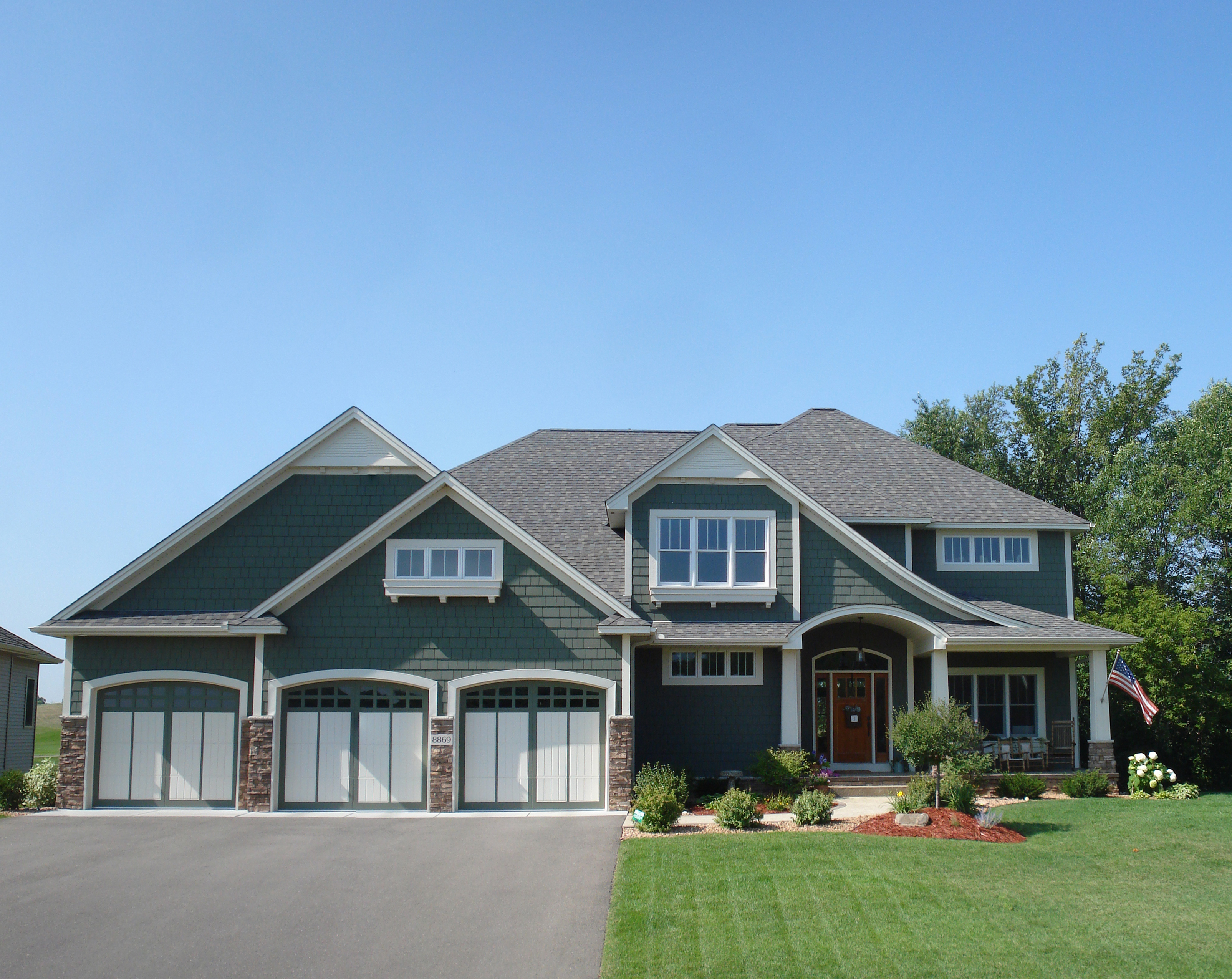 Completed two-story Minnesota home with a dark gray asphalt-shingle roof