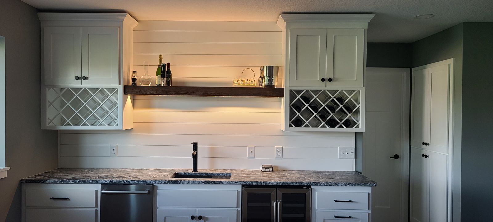 Finished basement wet bar with custom cabinetry by Minnesota Remodeling Solutions